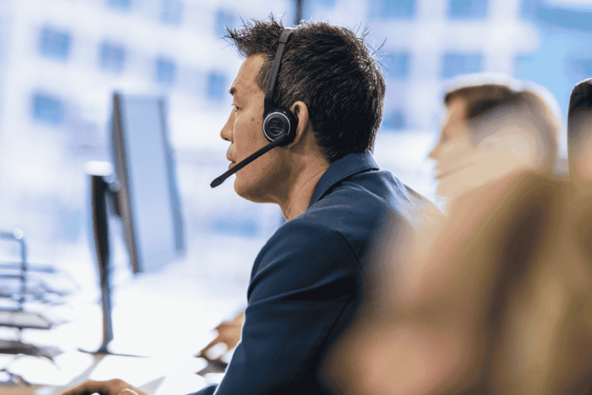 man with headset on IT helpdesk